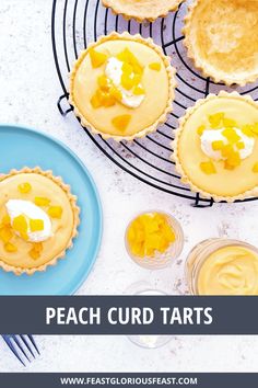 peach curd tarts on a cooling rack with lemons and whipped cream in the background