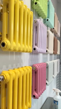 the colorful radiators are lined up on the wall