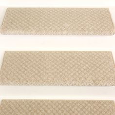 three beige rugs on white background with one in the middle and one in the bottom