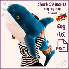 a person holding a stuffed shark in front of their face with the caption shark 39 inches, step - by - step