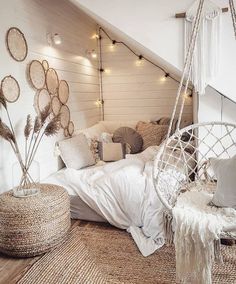 a bedroom with a hammock hanging from the ceiling and pillows on the bed