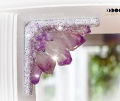 the window is decorated with purple crystals