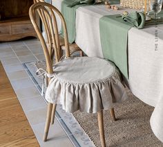 a dining room table with two chairs and a place mat on the floor next to it