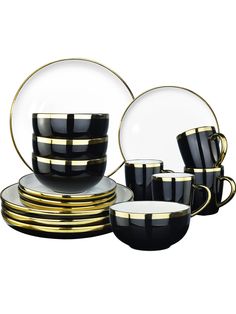 black and gold dinnerware set with plates, cups and saucers on white background