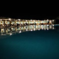 an empty swimming pool at night with lights on