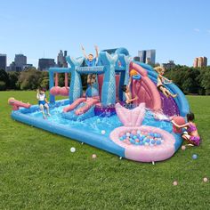 children playing in an inflatable water park