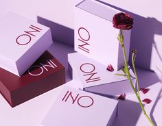 a single rose is sitting on top of three boxes with the word one in it