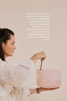 a woman holding a pink cake on top of a white plate with a quote above it