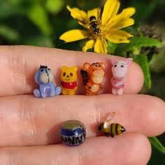 small toy animals are placed in the palm of someone's hand