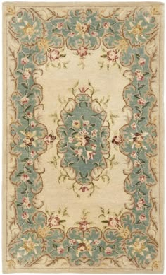 a blue and beige rug with flowers on the bottom, in an ornate pattern around it