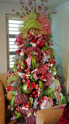 a christmas tree decorated with candy canes and bows