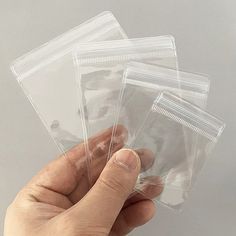 three clear plastic bags held in one hand