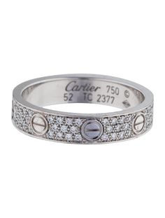 a white gold and diamond ring with the name cartier on it's side