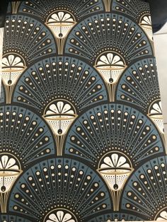 an art deco wallpaper design with gold and blue fan shapes on it's side