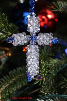 a christmas ornament hanging from a tree with the words make an easy bead christmas