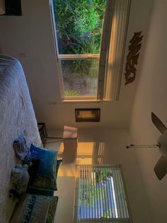 a bed room with a neatly made bed and a window