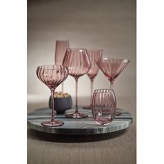 six pink wine glasses on a marble tray