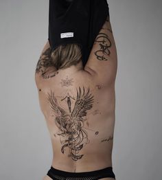 the back of a man with tattoos on his body