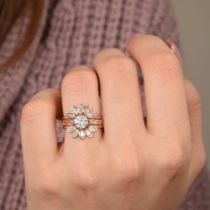 a woman's hand with a ring on it and a flower in the middle