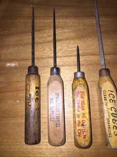 four old tools are lined up on a table