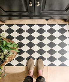 a person standing in front of a black and white checkered floor