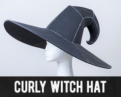 a white mannequin head wearing a black hat with the words curly witch hat on it