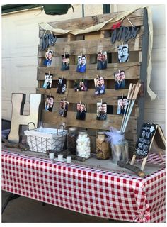 a table topped with pictures and candles on top of a checkered cloth covered table