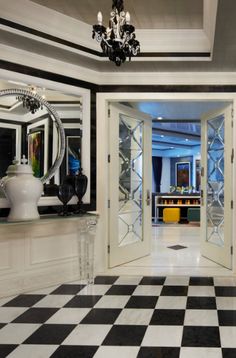 a black and white checkered floor with two mirrors on the wall next to it