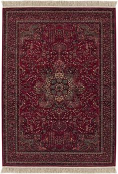 a red rug with an intricate design on the center and fringes hanging from it