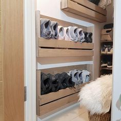 there are many pairs of shoes on the shelves in this closet, and one is empty