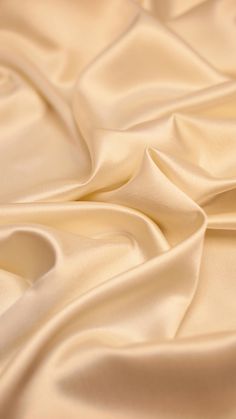 a close up view of a white satin fabric