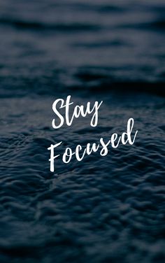 the words stay focused are written in white on a dark blue background with wavy water