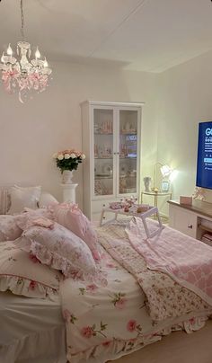 a bedroom with a large bed and chandelier in front of a tv on the wall