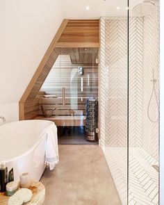 a bathroom with a white bath tub sitting next to a walk in shower and a wooden ceiling