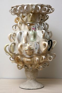 there is a sculpture made out of cups and saucers