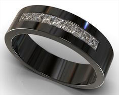 a wedding band with princess cut diamonds set in black and white gold, on a reflective surface