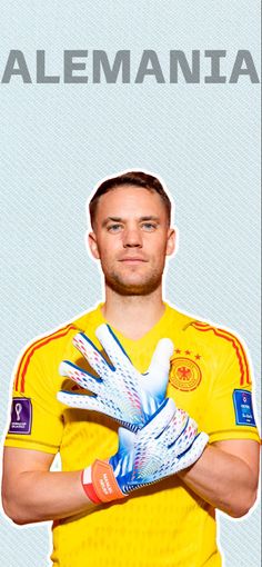 the soccer player is holding his hands up in front of him, and wearing gloves