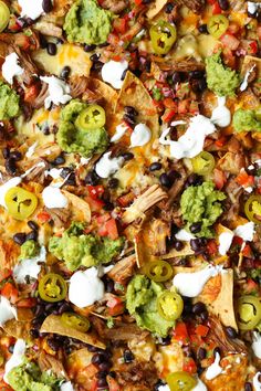 a pizza topped with lots of different types of vegetables and toppings on top of it