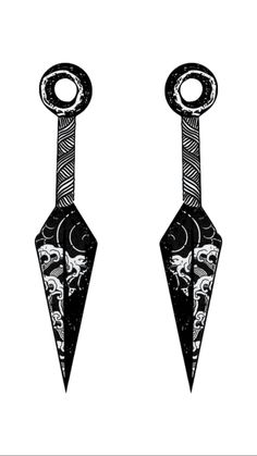 two black and white earrings with skulls hanging from the end of each ear, on a white background