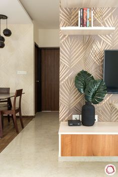 a living room with a tv, table and chairs next to a wall mounted television