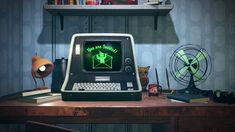 an old computer sitting on top of a wooden desk next to a fan and lamp