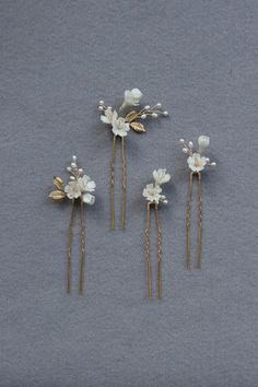 The prettiest feminine set of 4 delicate floral hair pins. They feature hand sculpted flowers, small leaves and sprigs of pearls and high quality life like brass leaves, all hand wired and attached to hair pins. Scatter these pins to adorn a romantic/tousled updo or half up hairstyle, or place them neatly in a row for a more polished look. Designer note: we understand finding the perfect hair piece can be challenging sometimes so we designed this set of hair pins to suit a range of hairstyles and to be used with various combinations - we are showing you 3 different ways to style them in the listing photos but there's no limit to your creativity. They're also the perfect adornment if you plan to have two different hairstyles on your special day.  DETAILS - Designed and handmade in Sydney, A Sculpted Flowers, Tousled Updo, Half Up Hairstyle, Floral Wedding Hair, Elegant Floral Wedding, Flower Hair Pieces, Floral Hair Pins, Small Leaves, Wedding Hair Pins