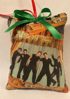 an ornament hanging from the side of a bag that has some pictures on it