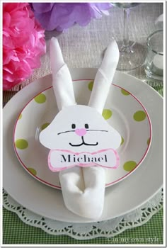 a white plate topped with a bunny rabbit napkin holder