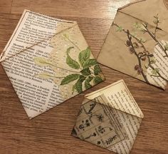 three pieces of paper sitting on top of a wooden table