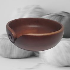 a large brown bowl sitting on top of a table