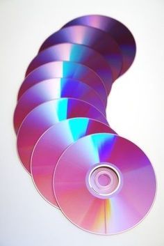 several cd's are stacked on top of each other in the shape of a spiral