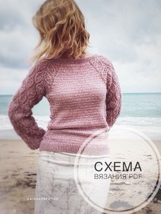 a woman standing on top of a sandy beach next to the ocean with her hands on her hips