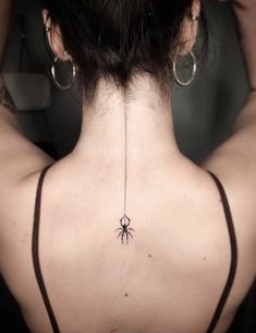 a woman with a spider tattoo on her back