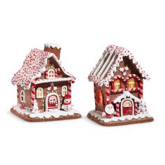 two gingerbread houses with candy canes on them